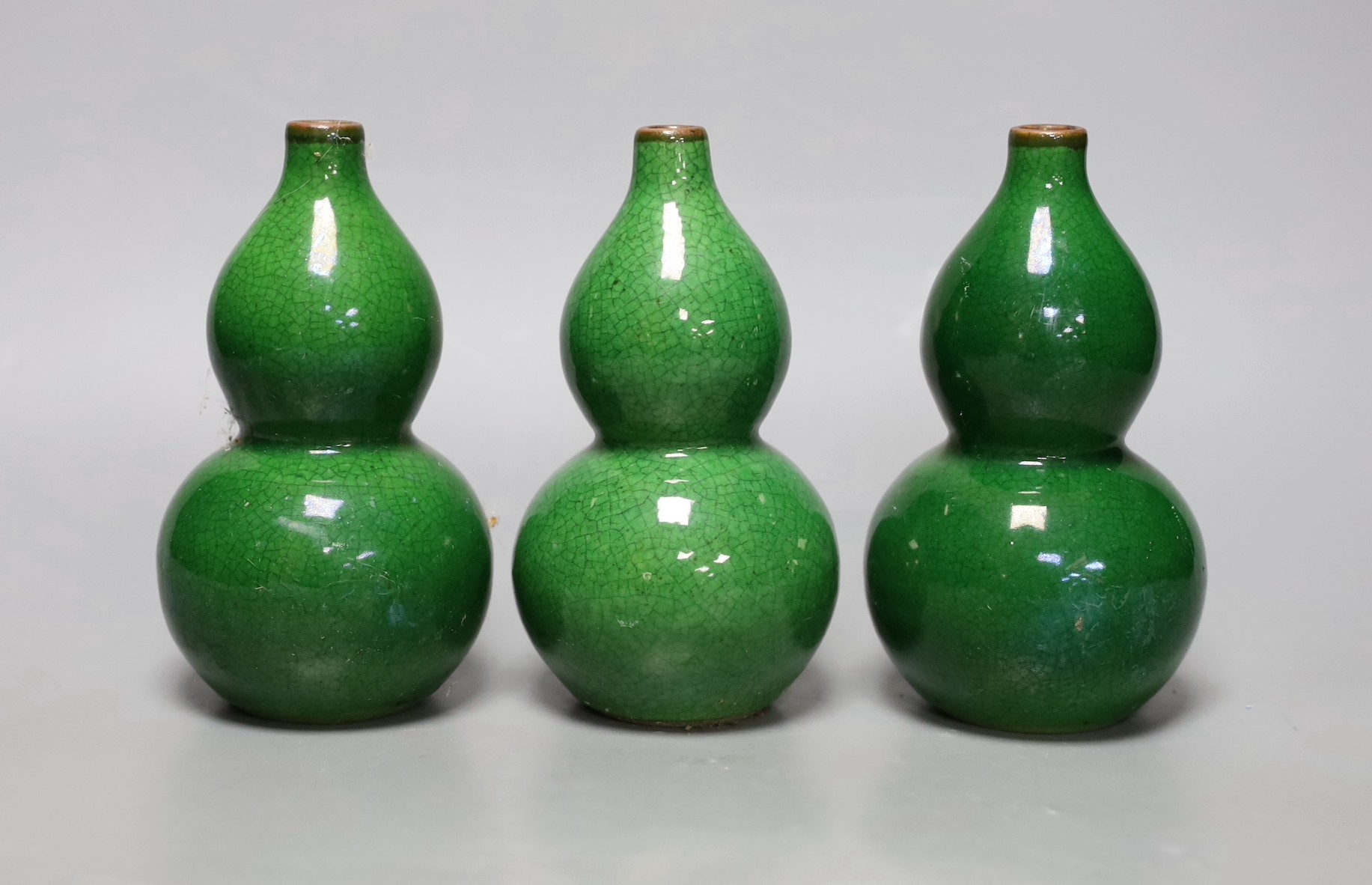 Three Chinese green crackle glazed double gourd vases, 15cm